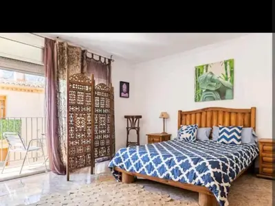 a bedroom with a large bed and a balcony at piso con vistas a la montaña in Monistrol