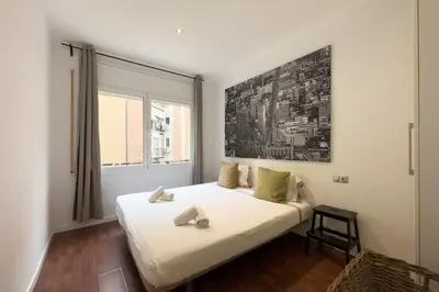 a bedroom with a large white bed and a window at Sagrada Familia Bliss in Barcelona