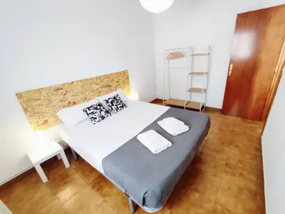 a bedroom with a bed and a ladder in it at Amplio apartamento con terraza in Hospitalet de Llobregat