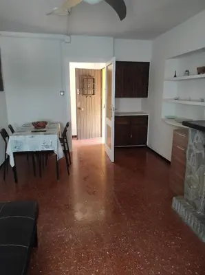 a living room with a table and a kitchen at Apartamentos Can Bruguera 4 in Mataró