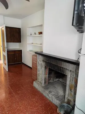 a living room with a fireplace and a tv at Apartamentos Can Bruguera 4 in Mataró