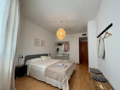 a bedroom with a bed in a white room at Cozy apartment well-located in Terrassa, Barcelona in Terrassa