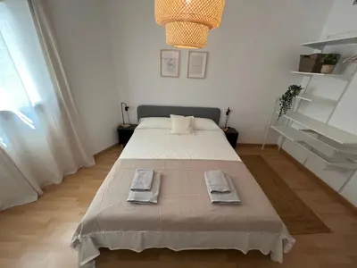 a bedroom with a bed with two towels on it at Cozy apartment well-located in Terrassa, Barcelona in Terrassa