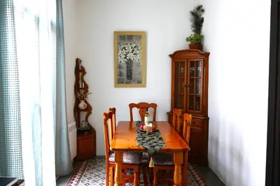 a dining room with a wooden table and chairs at La LLar de la Kim, Bonita casa a 150m del mar y 40km de Barcelona in Arenys de Mar