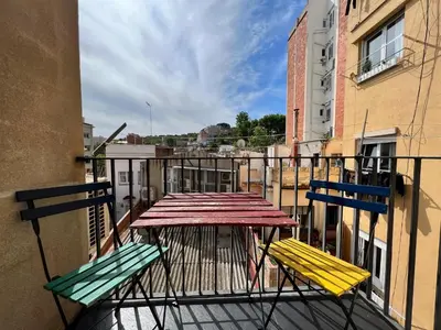a table and two chairs on a balcony at Teatro Miro Apartment in Barcelona