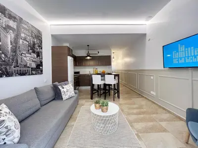 a living room with a couch and a table at Torre de Gracia Barcelona in Barcelona
