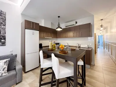 a kitchen and living room with a table and chairs at Torre de Gracia Barcelona in Barcelona