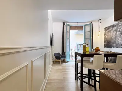 a kitchen and dining room with a table and chairs at Torre de Gracia Barcelona in Barcelona