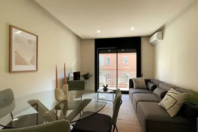 a living room with a couch and a glass table at Superflat near beach 15' center in Sant Adria de Besos