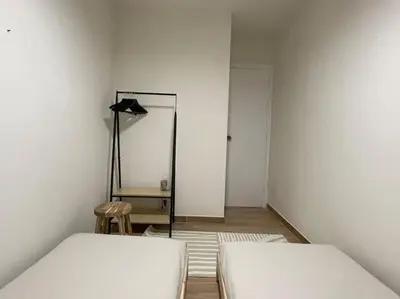 a room with two beds and a desk and a lamp at Superflat near beach 15' center in Sant Adria de Besos