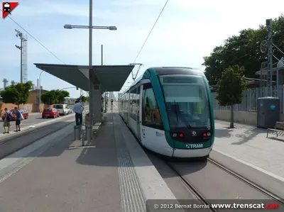 a green and white train at a train station at Superflat near beach 15' center in Sant Adria de Besos
