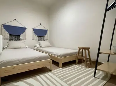 a bedroom with two beds and a table at Superflat near beach 15' center in Sant Adria de Besos