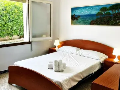 a bedroom with a bed with two towels on it at AFRODITA Casa con dos apartamentos independientes in Pineda de Mar