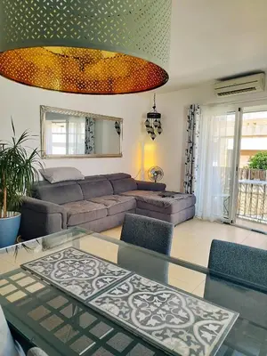 a living room with a couch and a glass table at SITGES WELCOM HOME a summer flat in the heart of the village Sitges in Sitges