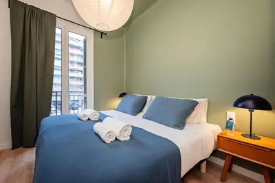 a bedroom with a large bed with towels on it at Sweett - Casa Miro in Barcelona
