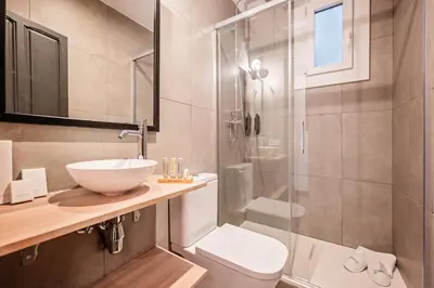 a bathroom with a sink and a toilet and a shower at Sweett - Casa Miro in Barcelona