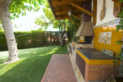 a backyard with a brick wall and a stove at Catalunya Casas Private paradise - hop, skipjump to Barcelona! in Cervelló