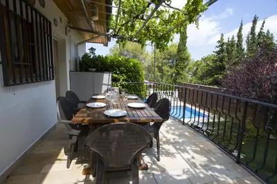 a table and chairs on the balcony of a house at Catalunya Casas Private paradise - hop, skipjump to Barcelona! in Cervelló
