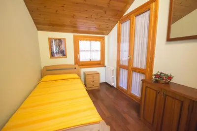 a bedroom with two beds in a room with wooden floors at Catalunya Casas Private paradise - hop, skipjump to Barcelona! in Cervelló