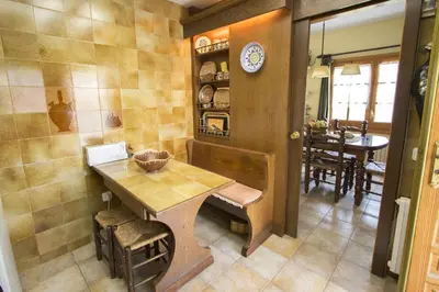a kitchen with a wooden table and a dining room at Catalunya Casas Private paradise - hop, skipjump to Barcelona! in Cervelló