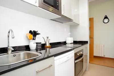 a kitchen with a sink and a microwave at Attic Bcn Central Terrace in Barcelona