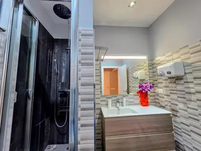 a bathroom with a sink and a shower at Luxury Central Apartment in Barcelona