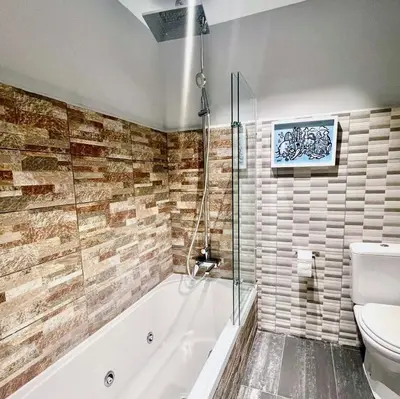 a bathroom with a tub and a toilet at Luxury Central Apartment in Barcelona
