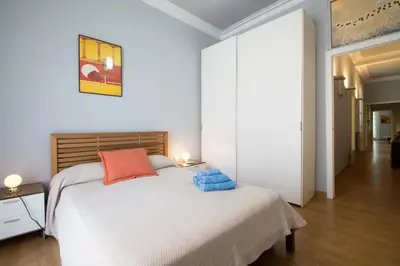 a bedroom with a white bed with blue towels on it at Luxury Central Apartment in Barcelona
