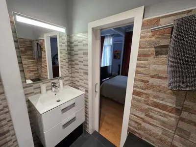 a bathroom with a sink and a mirror at Luxury Central Apartment in Barcelona