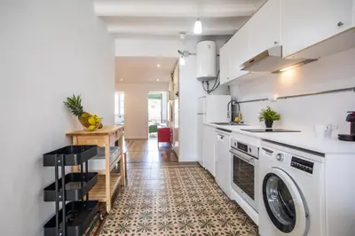 a kitchen with a washer and dryer at BBarcelona Sants Flat in Barcelona