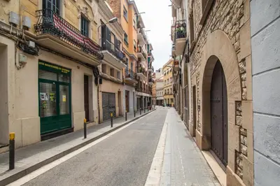 an empty street in an alley between buildings at BBarcelona Sants Flat in Barcelona