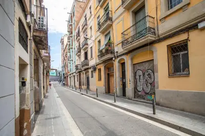 an empty street in a city with buildings at BBarcelona Sants Flat in Barcelona