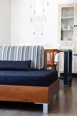 a couch sitting in a living room with a table at Apartment Vila Olímpica Barcelona next to beach & garden in Barcelona