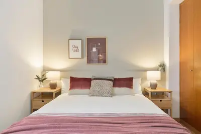 a bedroom with a large bed with two night stands at Click&Flat Sugranyes in Barcelona
