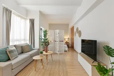 a living room with a couch and a tv at Click&Flat Sugranyes in Barcelona