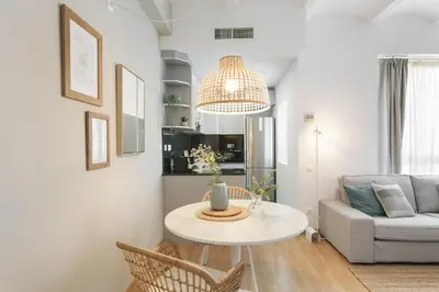 a living room with a table and a couch at Click&Flat Sugranyes in Barcelona