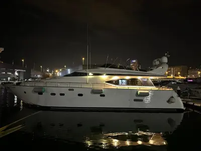 a white boat sitting in the water at night at YACHT 20Metros in Barcelona