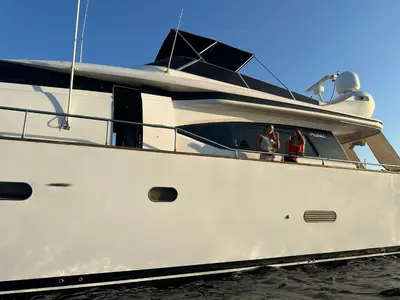 two women are sitting on a boat in the water at YACHT 20Metros in Barcelona