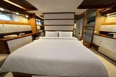 a large white bed in a small room at YACHT 20Metros in Barcelona