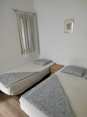 two twin beds in a room with a window at Sant Adrià in Sant Adria de Besos
