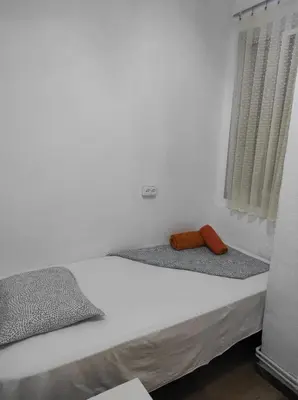 a small white room with a bed and a window at Sant Adrià in Sant Adria de Besos