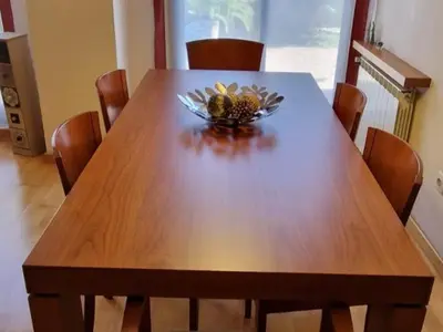 a wooden table with a bowl of flowers on it at Homing Sabadell 73 in Sabadell