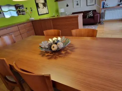 a bowl of flowers on a wooden table at Homing Sabadell 73 in Sabadell