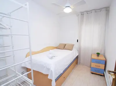 a small bedroom with a bed and a window at Gaudi Contemporani in Mataró