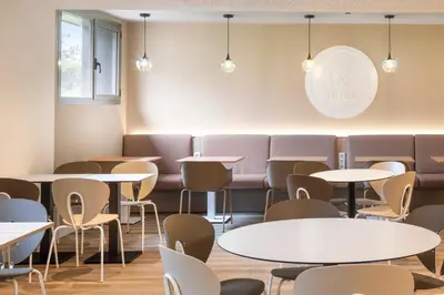 a dining room with tables and chairs at B&B HOTEL Barcelona Sant Cugat in Sant Cugat del Vallès
