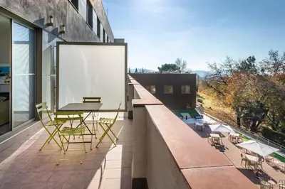 a balcony with a table and chairs on a building at B&B HOTEL Barcelona Sant Cugat in Sant Cugat del Vallès