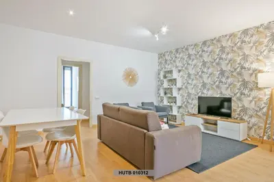a living room with a couch and a tv at Alcam Glorias in Barcelona
