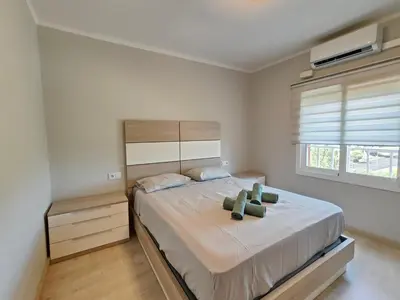 a bedroom with a large bed and a window at Family apartment Besos in Sant Adria de Besos
