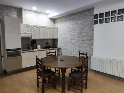 a kitchen with a table and chairs in a room at Apartamento a 10Km Barcelona, Jardin, Luminoso in Martorellas