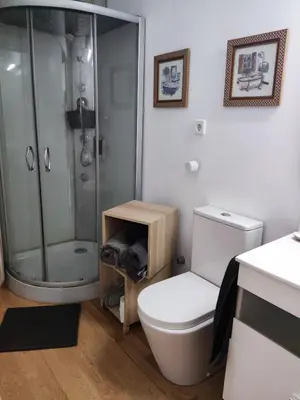 a bathroom with a white toilet and a shower at Apartamento a 10Km Barcelona, Jardin, Luminoso in Martorellas
